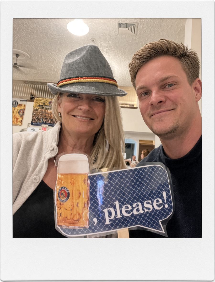Clayton and Sharyn in an Oktoberfest hat holding a Paulaner stein photo prop at Heimat in Windsor