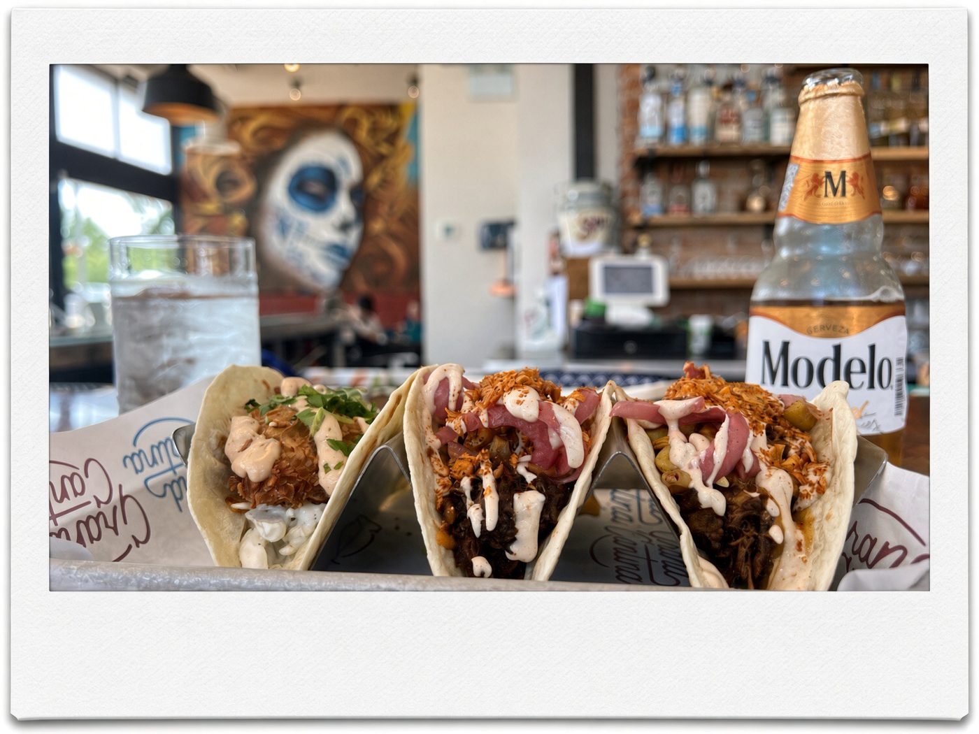 Three loaded tacos with crema and a Modelo at The Grand Cantina in Walkerville, Windsor